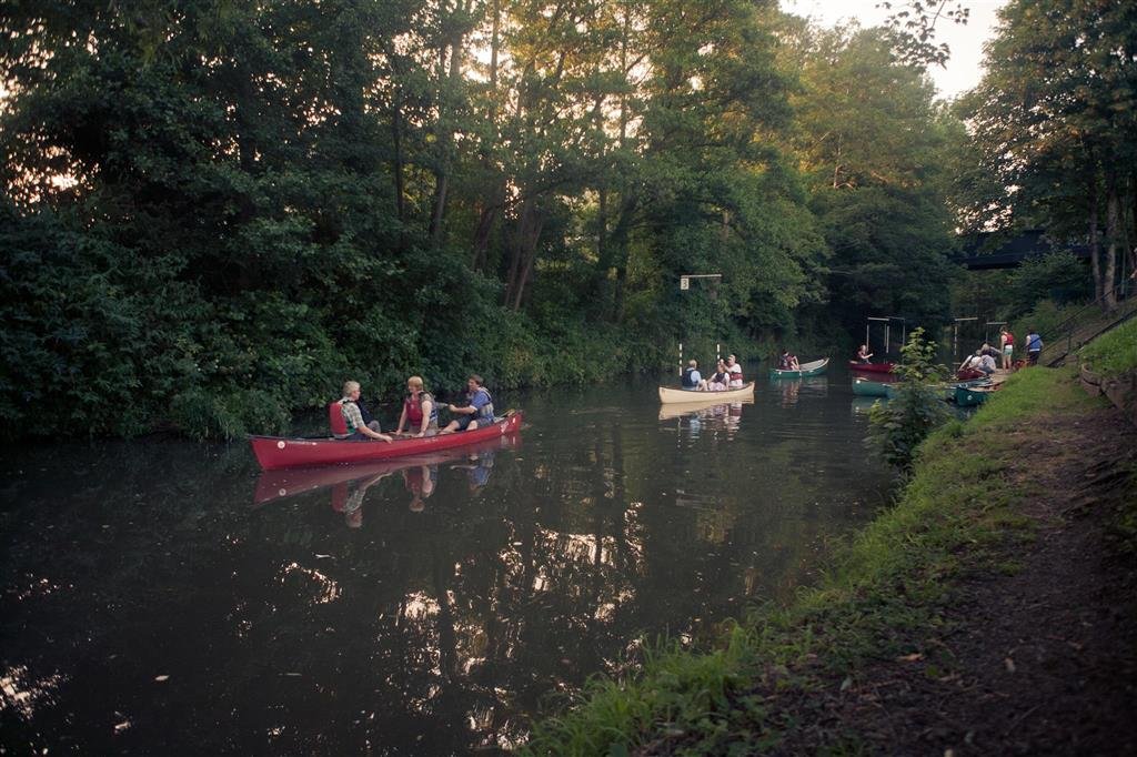 Audience canoes on the river before the performance. Photograph by Alex Green.